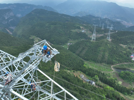 图为4月29日,国网重庆电力员工在逾100米高的特高压输电线路上作业。李奕 摄 图为4月29日,国网重庆电力员工在逾100米高的特高压输电线路上作业。李奕 摄