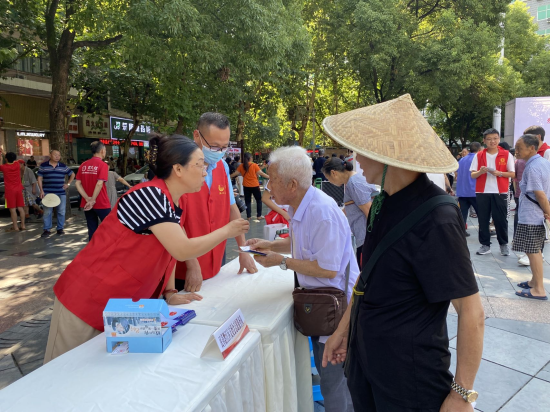 图为志愿者向市民开展法律咨询。 黔江区委统战部供图 图为志愿者向市民开展法律咨询。 黔江区委统战部供图
