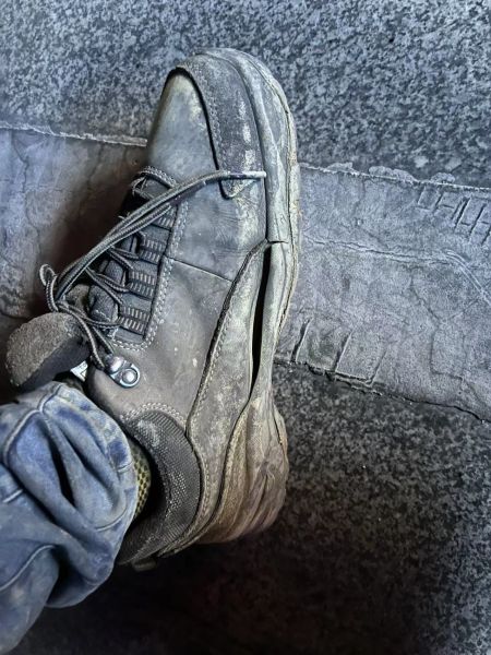 图为张傲脚下被地面高温烤开裂的工鞋。 受访者供图