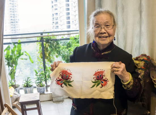 图为周有玉展示手工作品 。陈鑫 摄 图为周有玉展示手工作品 。陈鑫 摄