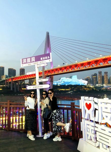 图为4月11日,游客在洪崖洞客运码头前合影。 秋狸 图为4月11日,游客在洪崖洞客运码头前合影。 秋狸