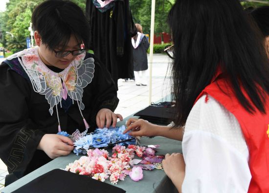 图为毕业生制作簪花学位帽。周毅 摄 图为毕业生制作簪花学位帽。周毅 摄