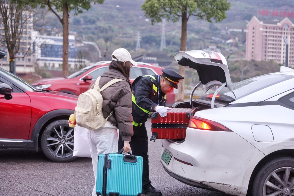 图为执法人员为市民搬运大件行李。重庆交通执法部门供图 图为执法人员为市民搬运大件行李。重庆交通执法部门供图