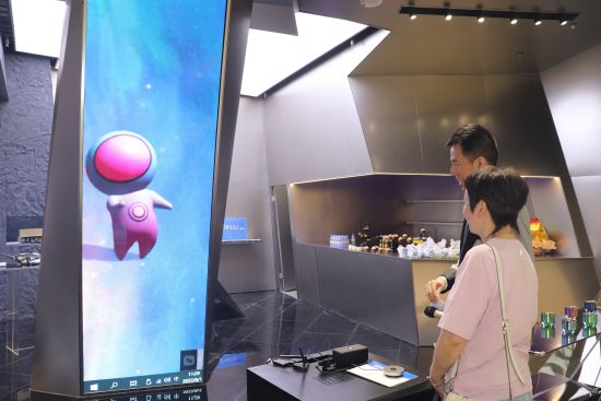 图为顾客与虚拟店员“钛小星”交流。 陈佳欣摄 图为顾客与虚拟店员“钛小星”交流。 陈佳欣摄