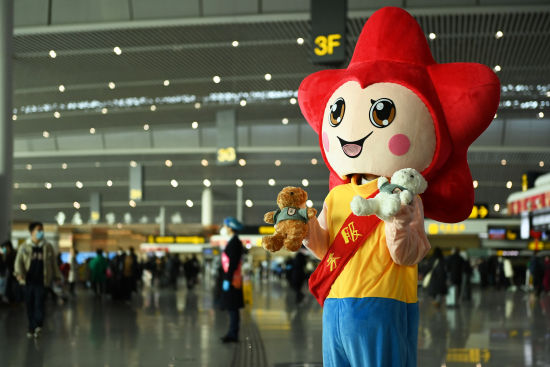 图为在重庆江北国际机场,一工作人员穿着玩偶服饰迎接旅客.陈超 摄