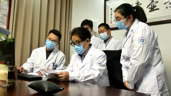 国医张大宁(中)查看病历。受访者供图 国医张大宁(中)查看病历。受访者供图