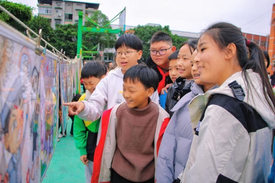 图为同学们围在一起观看禁毒手抄报。 刘亚兰 摄 图为同学们围在一起观看禁毒手抄报。 刘亚兰 摄