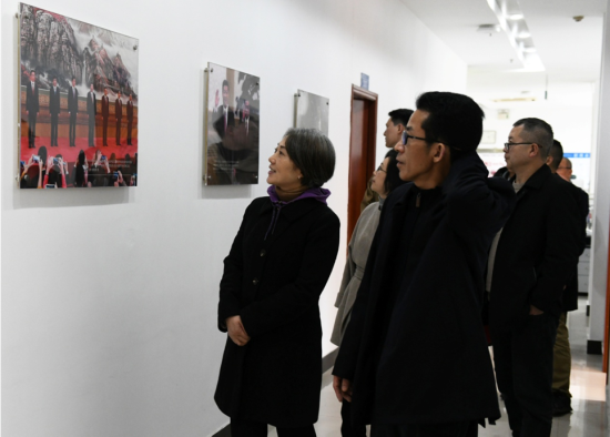 图为吴萍一行参观中新社重庆分社展示墙.周毅 摄