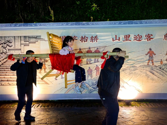 图为游客体验抬滑竿。代娟 摄 图为游客体验抬滑竿。代娟 摄